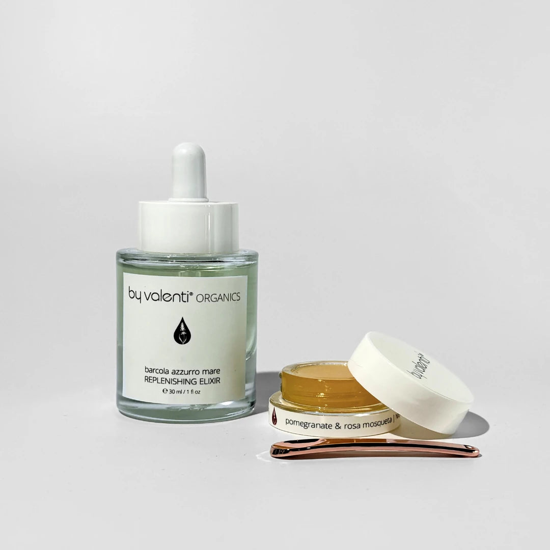 Two By Valenti skincare products including a dropper glass bottle and a jar on a light gray background