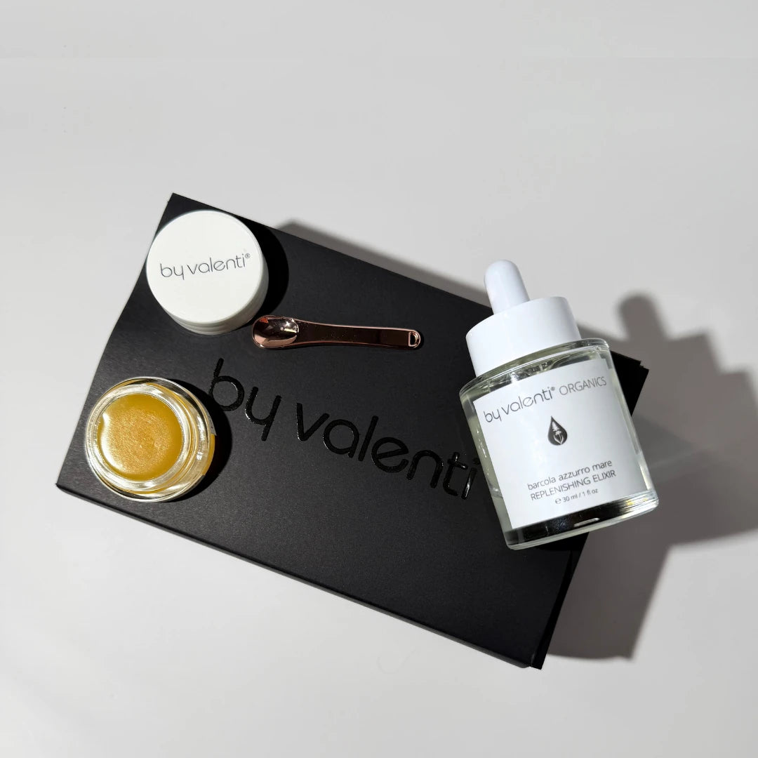 Two By Valenti skincare products with on a black By Valenti gift box.