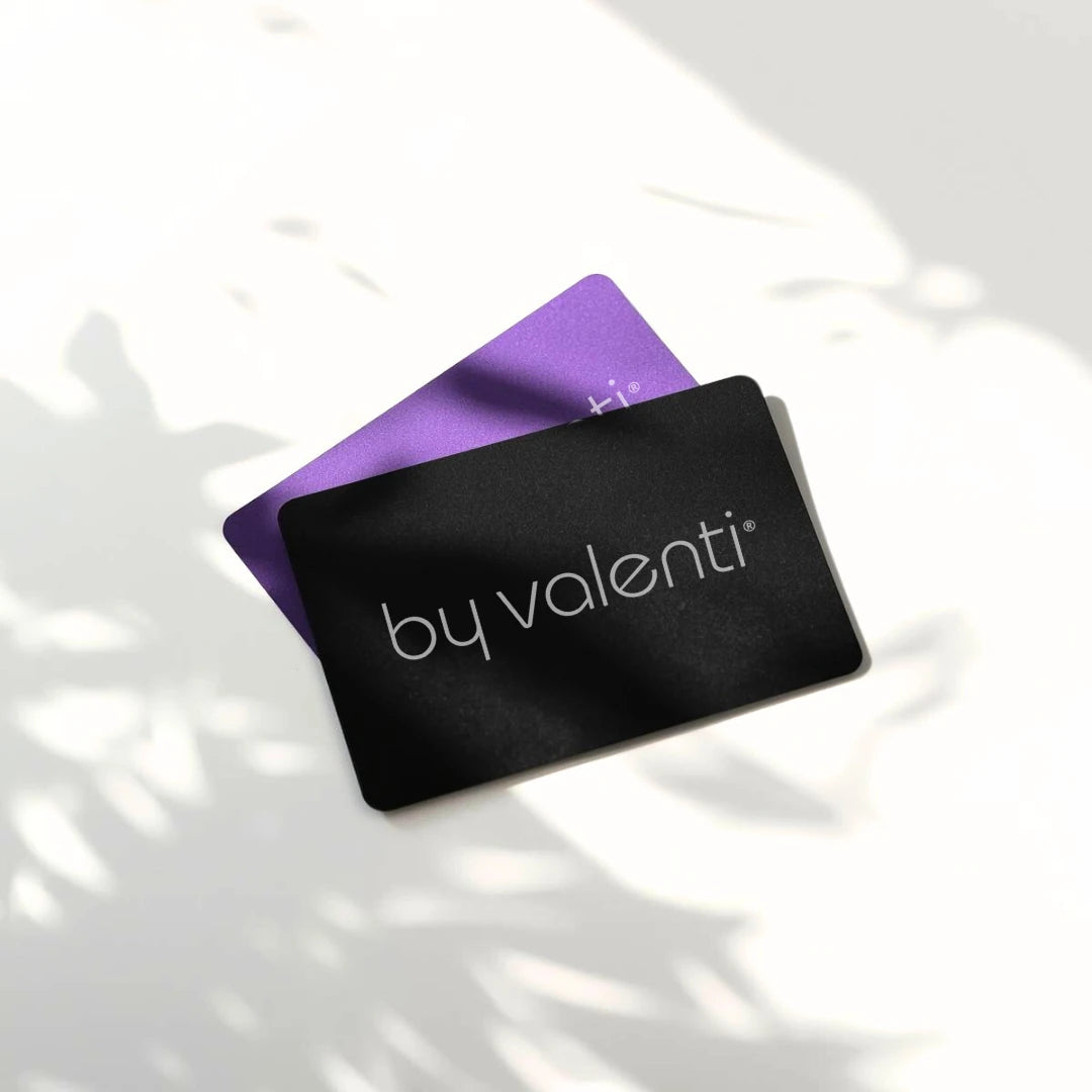 Two gift cards, one purple and one black, with 'by valenti' branding on a light background.