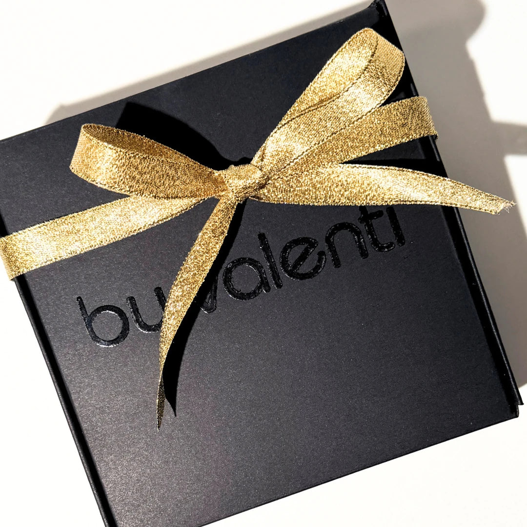 Black gift box with a gold ribbon featuring the brand 'By Valenti'.
