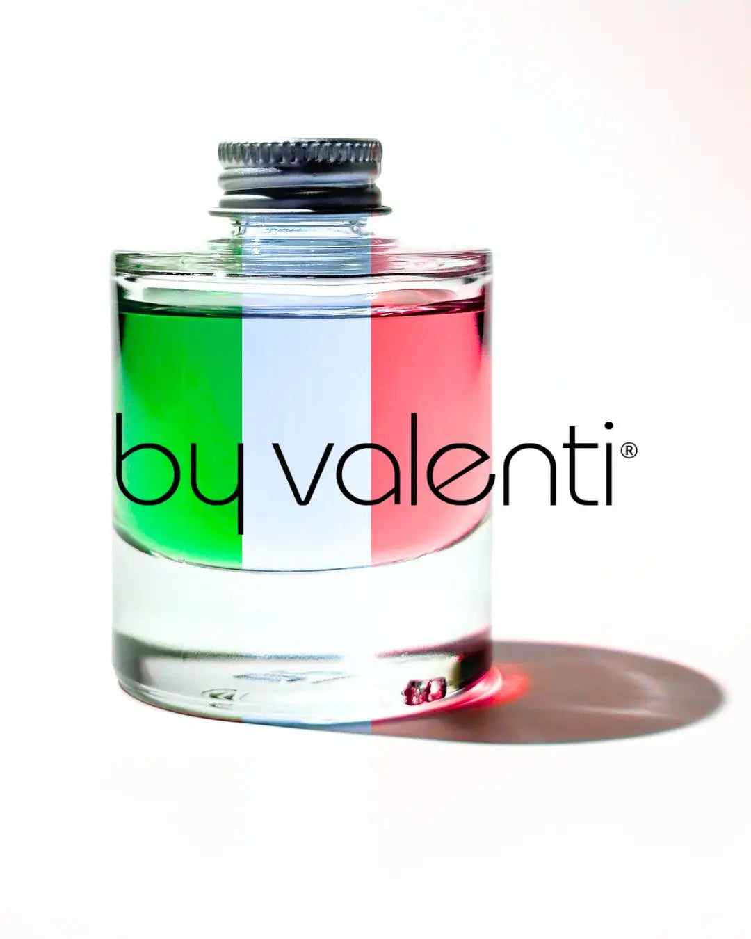 By Valenti Serum bottle with Italian flag design and 'by valenti' branding on a white background
