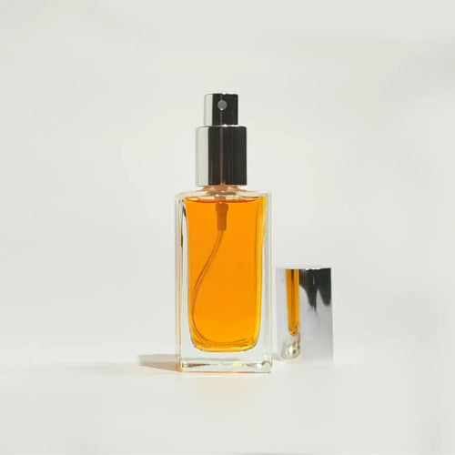 By Valenti New Trieste perfume bottle with orange perfume on a white background